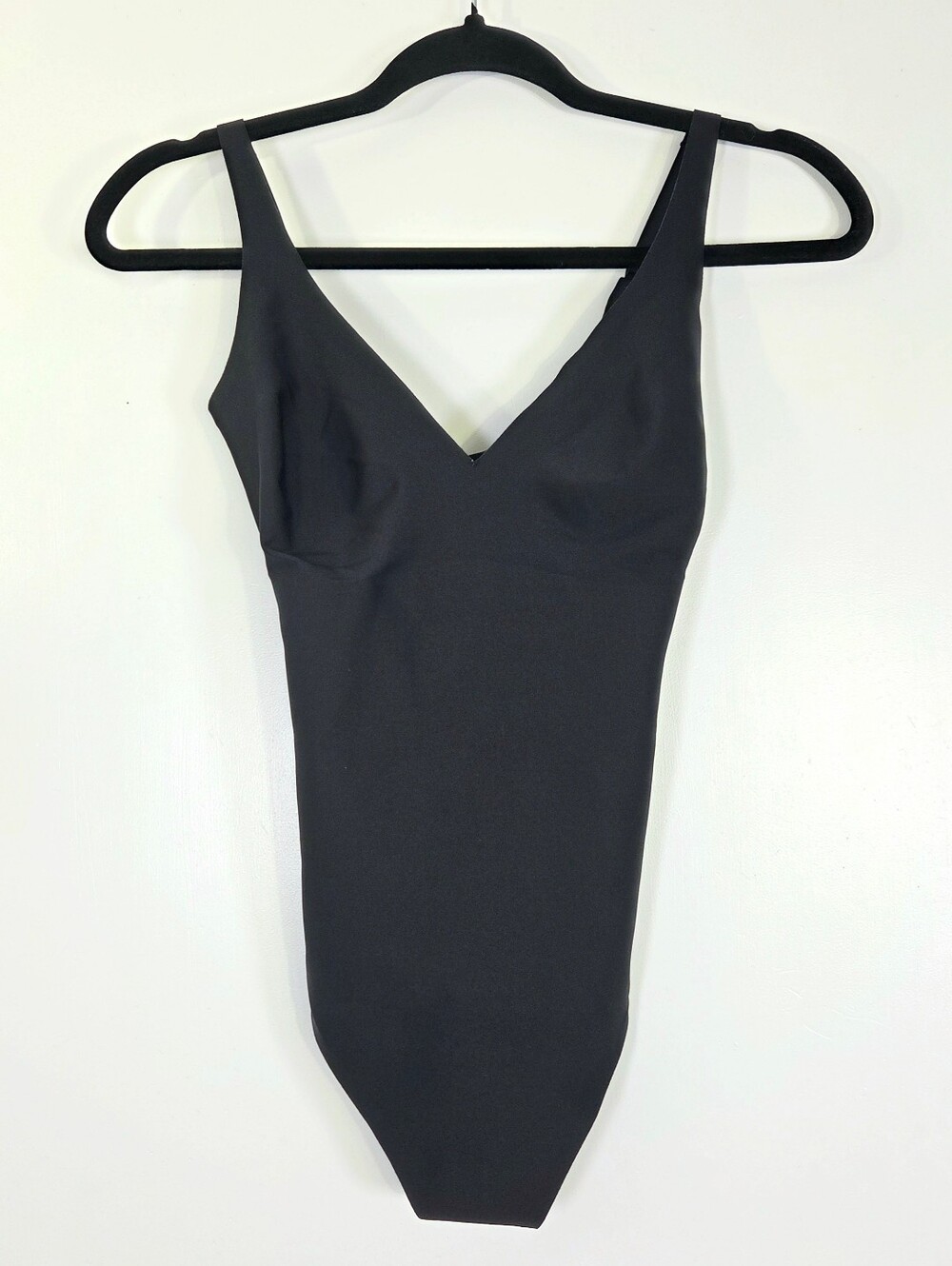 SKIMS BODY CORE SCULPT PLUNGE THONG BODYSUIT IN ONYX.